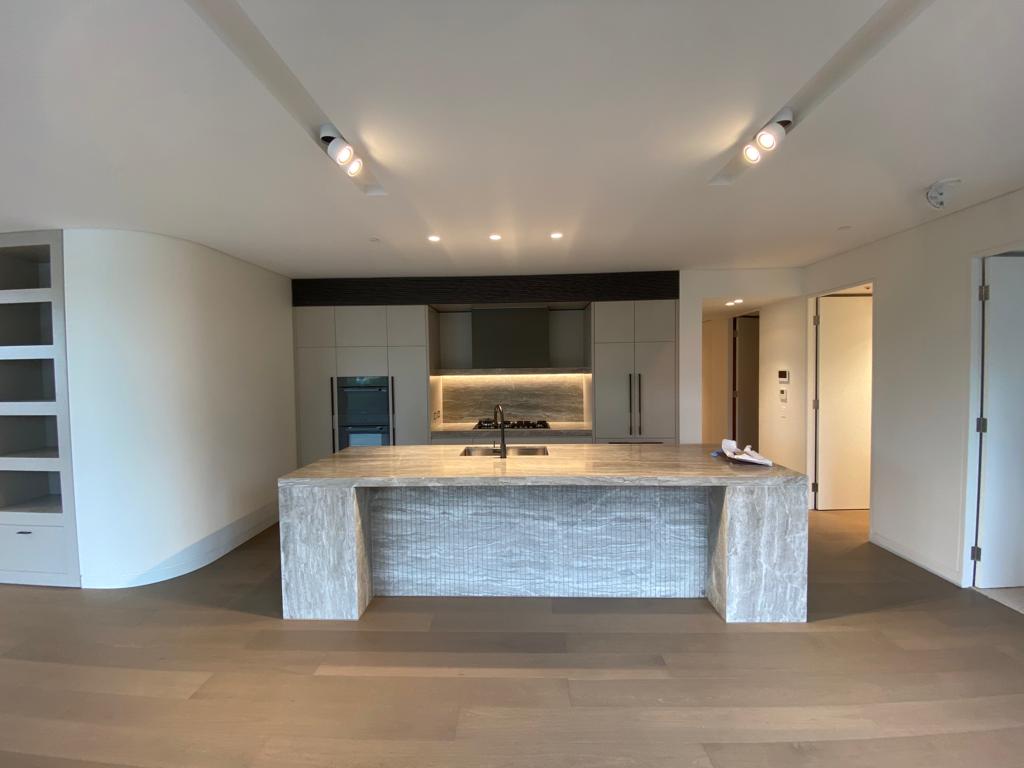 a kitchen interior looks beautiful after installing a lighting in the celling and around the stove.